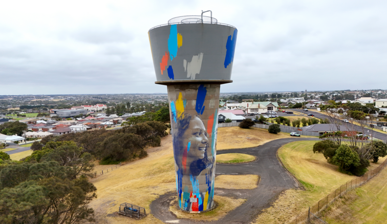 Aerial image of the West Warrnambool Water Tower with the city in the background on a cloudy day.