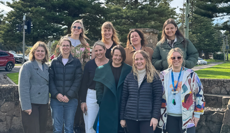 A group of women smiling at the camera before the July mentor walk